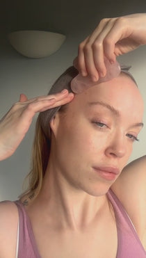 video of a girl using a facial massage gua sha