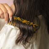model combing wide tooth comb through dry hair