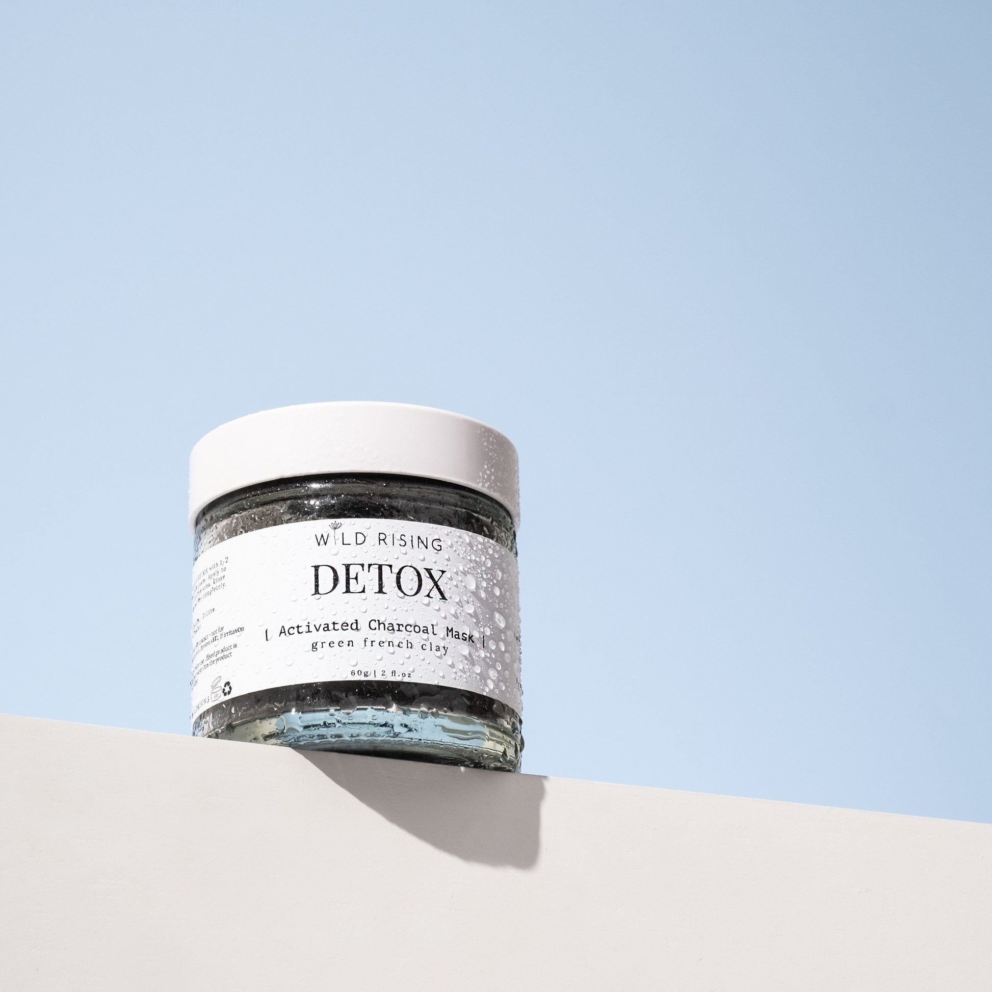 detox activated charcoal clay mask with water droplets